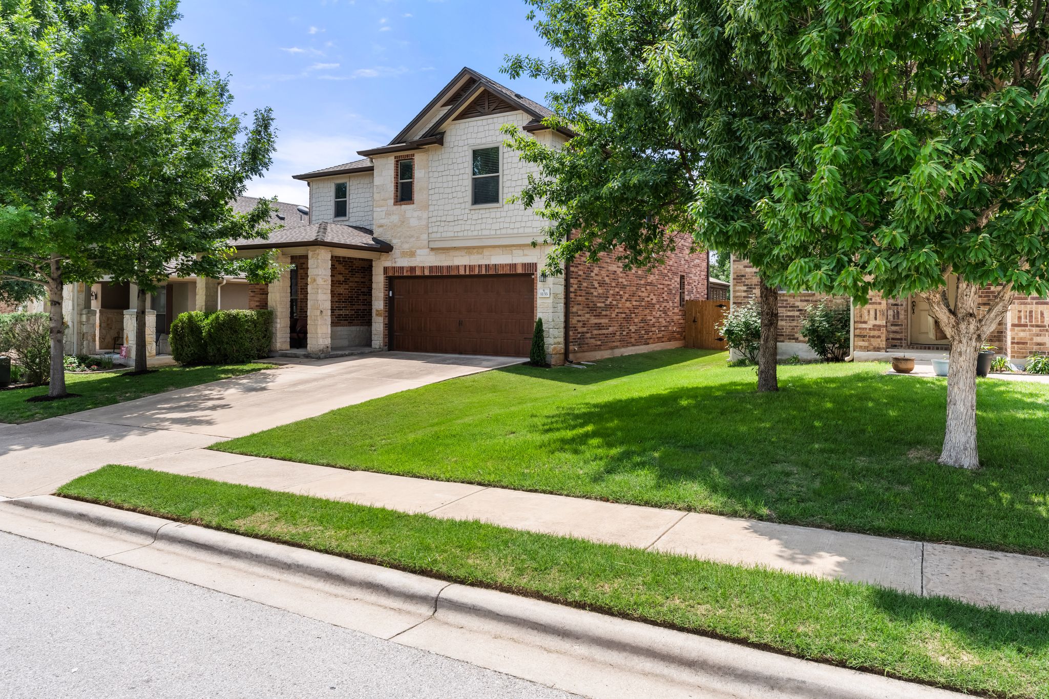 1133 Yellow Iris Road Leander, TX 78641 - Photo 29 of 37 Two-story residence featuring a mixed-material facade with stone, brick, and horizontal siding