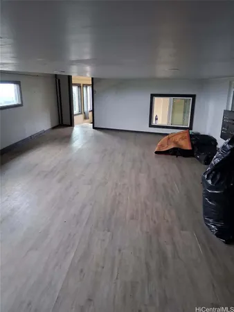 a view of a livingroom with wooden floor and a window