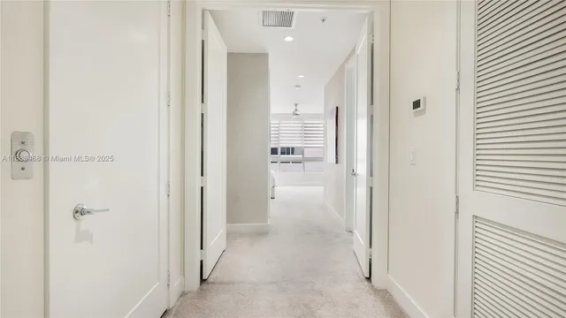 a view of a hallway with a bathroom