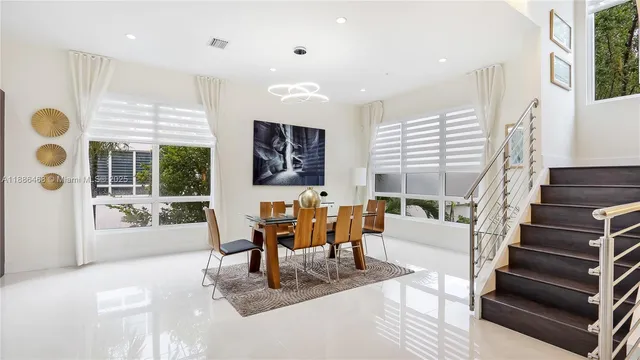 a living room with furniture and large windows