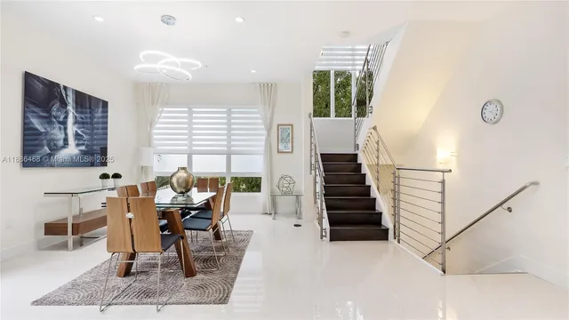 a dining room with furniture and entryway