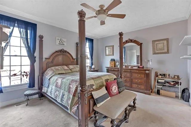 a bedroom with a bed couch and a window