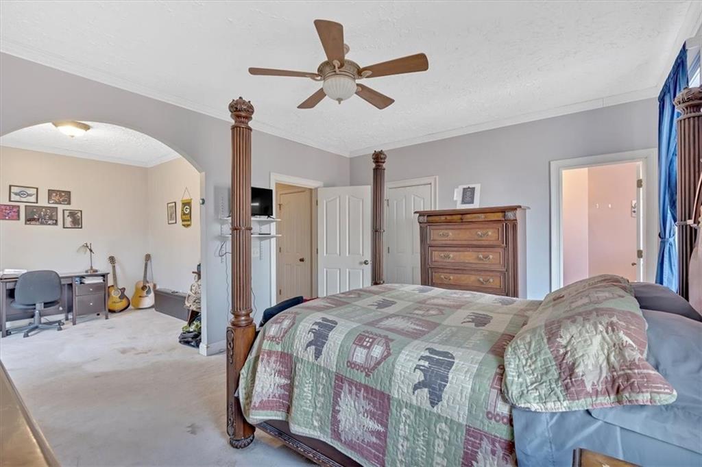 1430 Jasper Court Ranger, GA 30734 - Photo 24 of 49 a bedroom with a bed and a chandelier