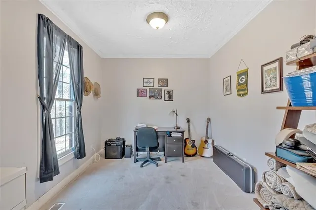 a view of room with workspace and windows