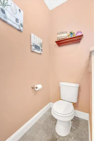 a white toilet sitting next to a bathroom sink