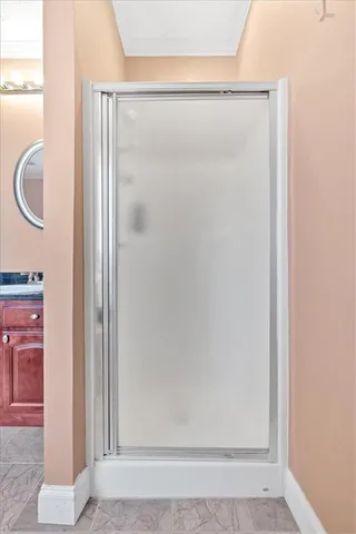 a bathroom with a glass shower door