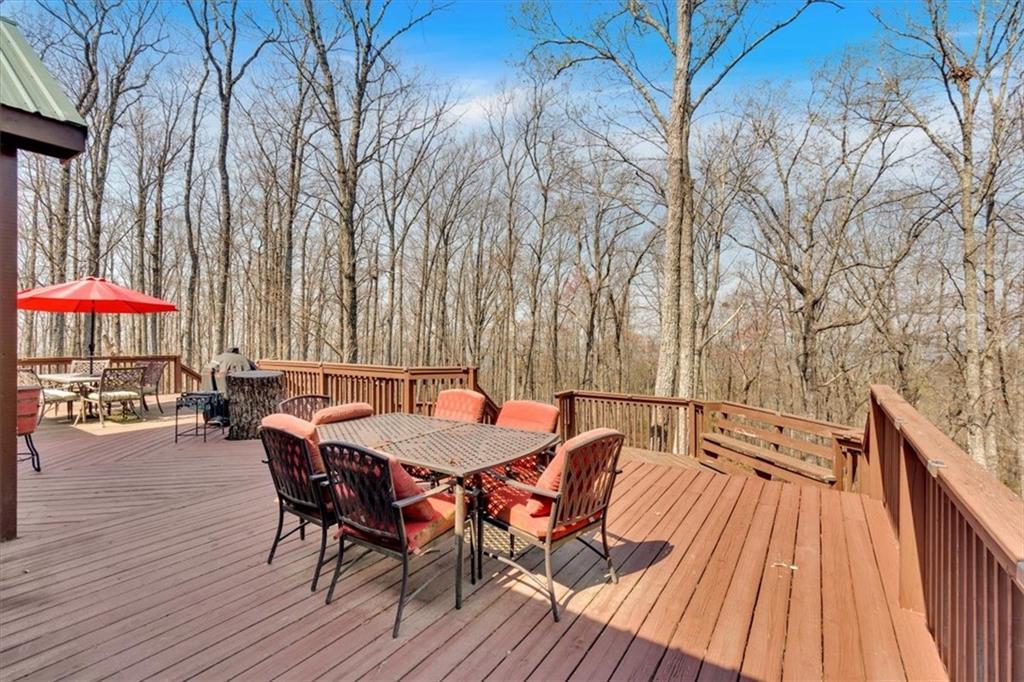 1430 Jasper Court Ranger, GA 30734 - Photo 36 of 49 a view of a roof deck with table and chairs wooden floor and fence