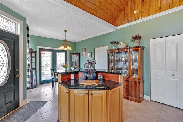 a kitchen with stainless steel appliances granite countertop a sink and a refrigerator