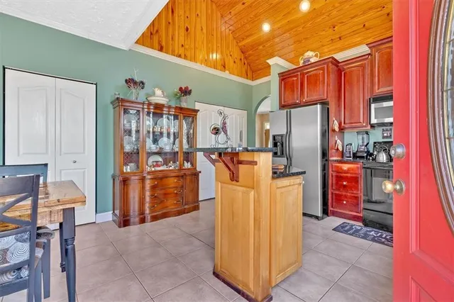 a utility room with refrigerator and washer