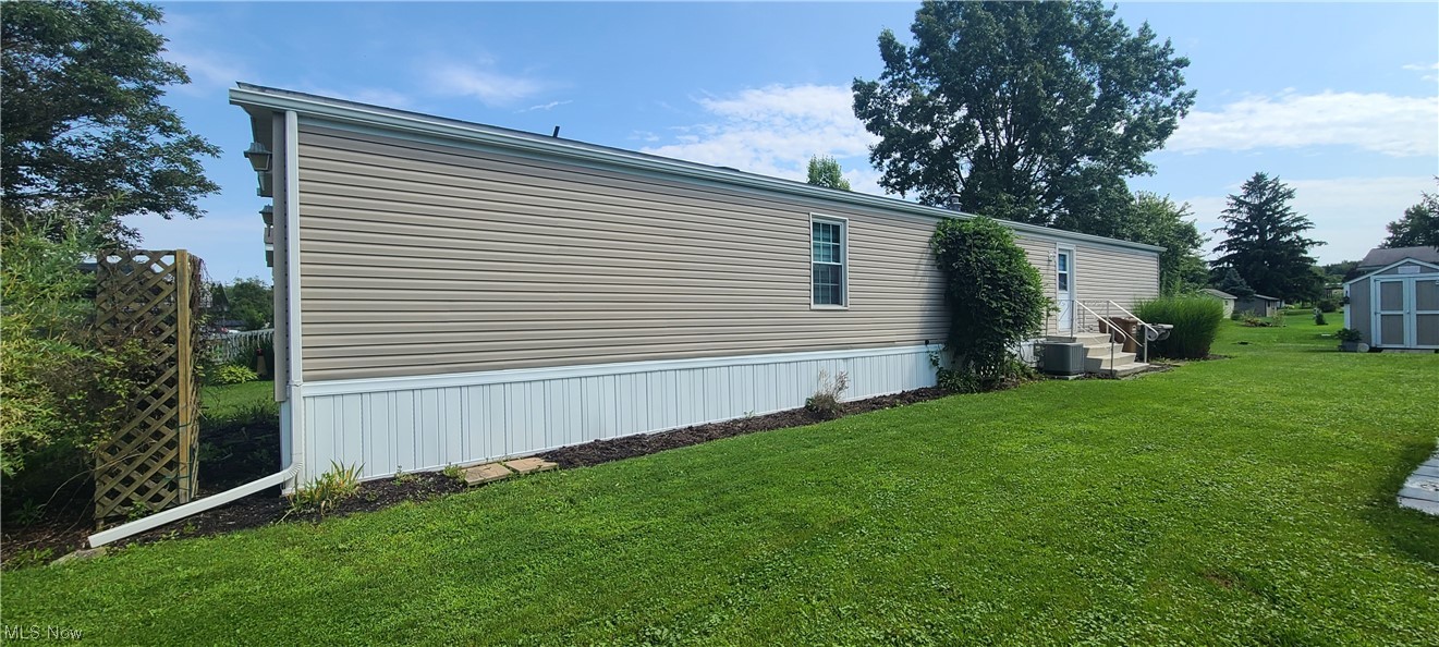 5974 Cleveland Road, Unit 19 Wooster, OH 44691 - Photo 4 of 17 View of side of property with a yard