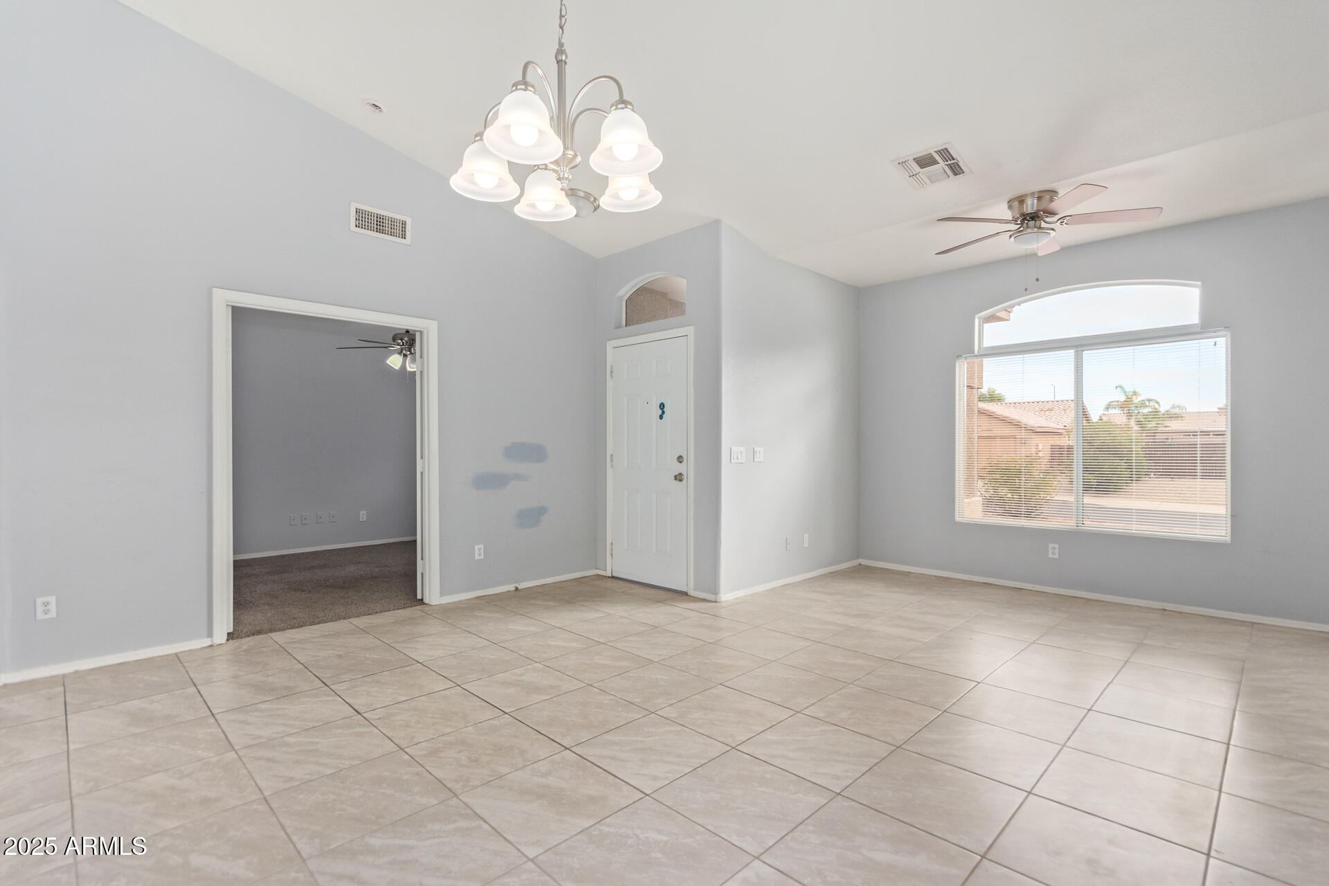 756 South Benton Mesa, AZ 85208 - Photo 2 of 9 an empty room with chandelier fan and windows