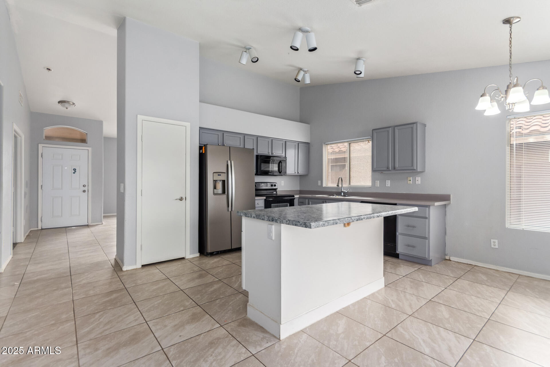 756 South Benton Mesa, AZ 85208 - Photo 3 of 9 a kitchen with kitchen island granite countertop stainless steel appliances cabinets a sink and a counter top space