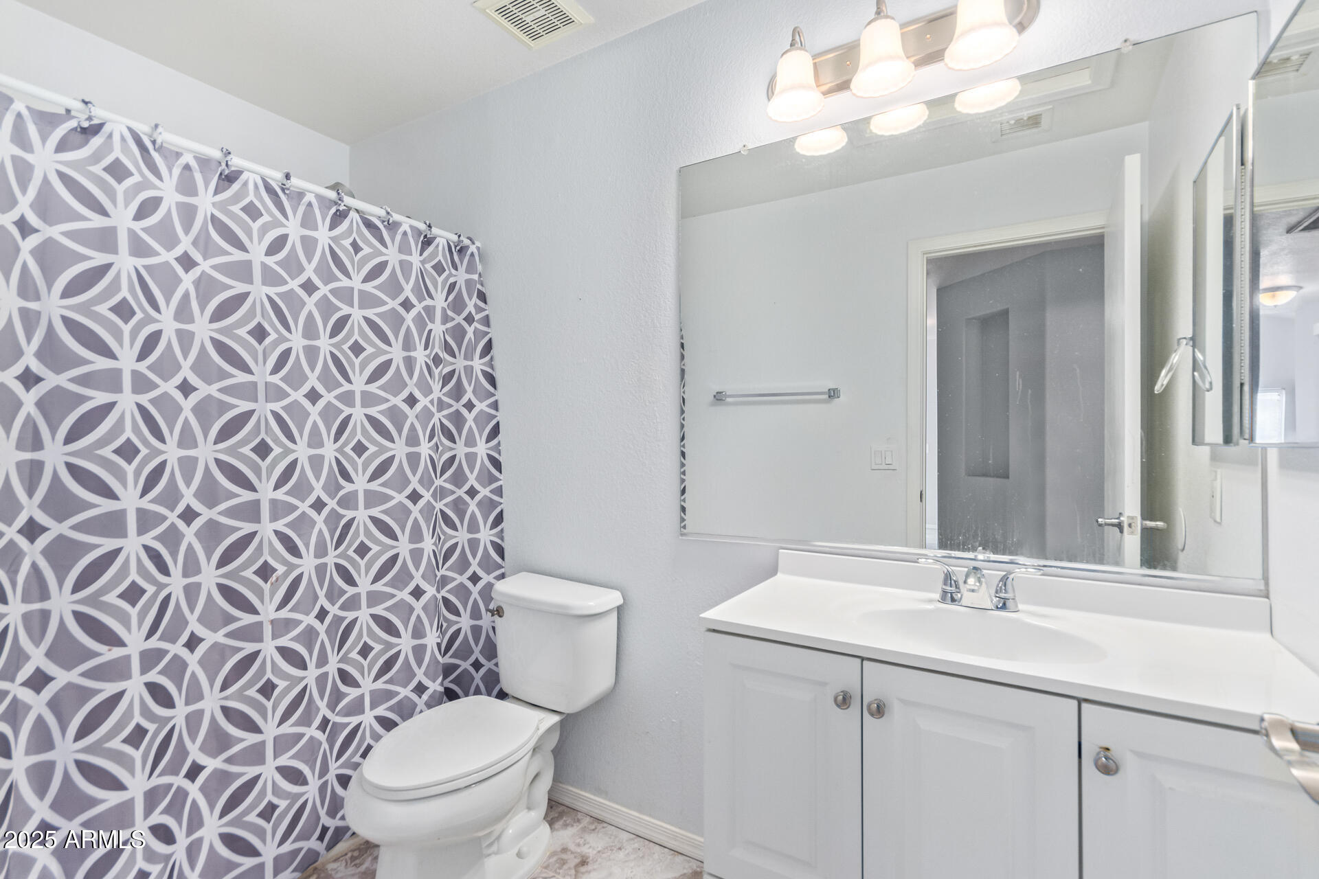 756 South Benton Mesa, AZ 85208 - Photo 7 of 9 a bathroom with a sink a toilet and a mirror