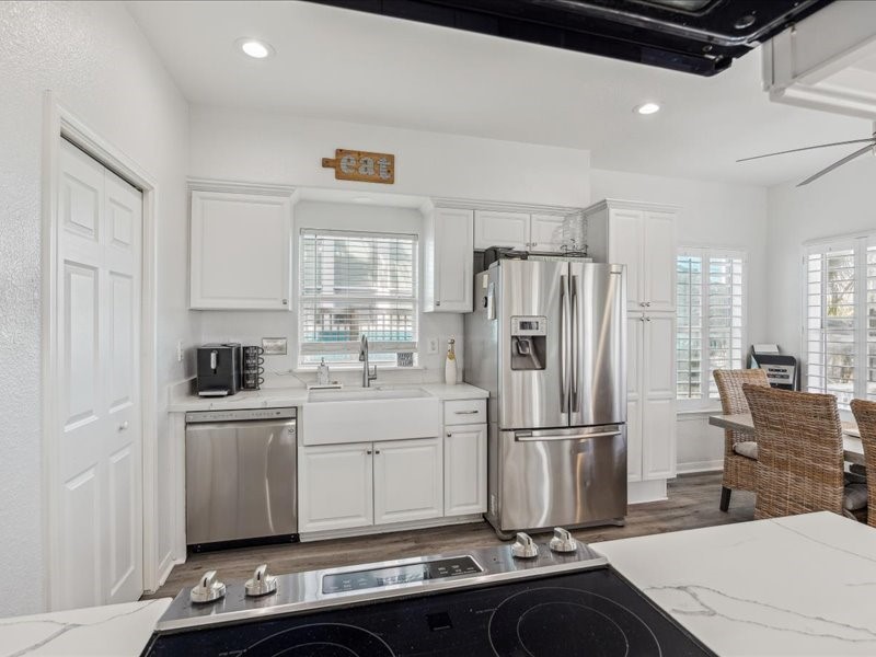 530 Dolphin Street Freeport, TX 77541 - Photo 11 of 29 a kitchen with stainless steel appliances granite countertop a refrigerator sink and stove