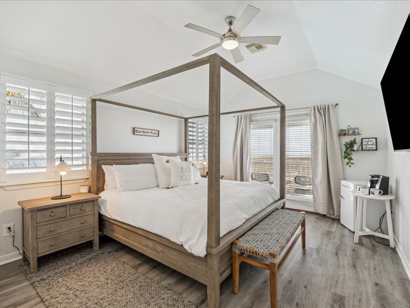530 Dolphin Street Freeport, TX 77541 - Photo 13 of 29 a bed room with a bed and a chandelier