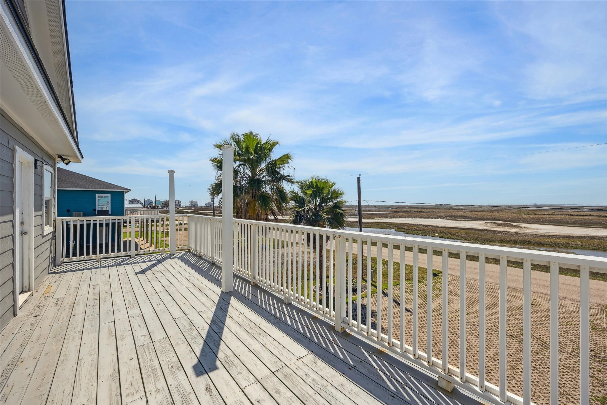 530 Dolphin Street Freeport, TX 77541 - Photo 19 of 29 a view of balcony with wooden floor and fence