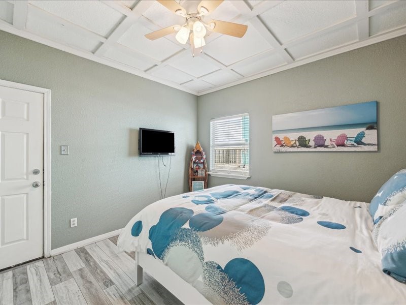 530 Dolphin Street Freeport, TX 77541 - Photo 20 of 29 a bedroom with a bed and a flat screen tv
