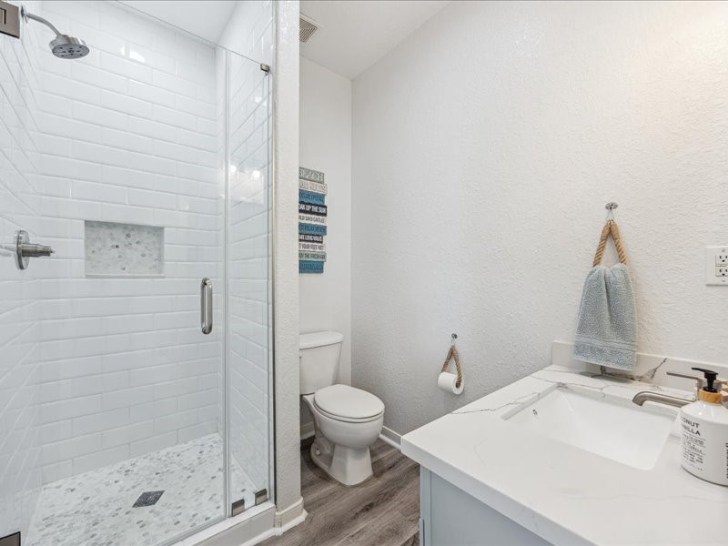 530 Dolphin Street Freeport, TX 77541 - Photo 21 of 29 a bathroom with a sink a toilet and shower