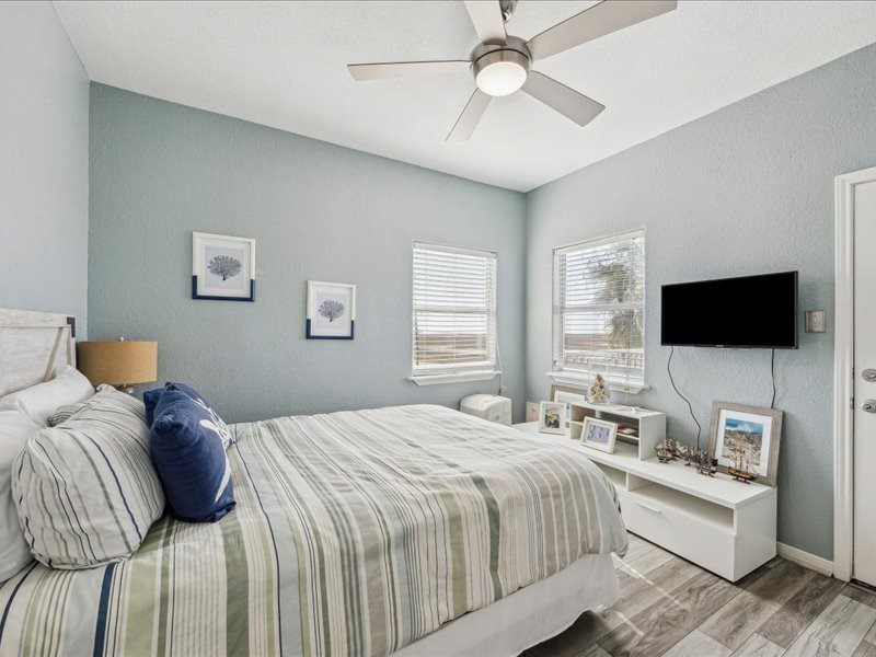530 Dolphin Street Freeport, TX 77541 - Photo 22 of 29 a bedroom with a bed and a flat screen tv