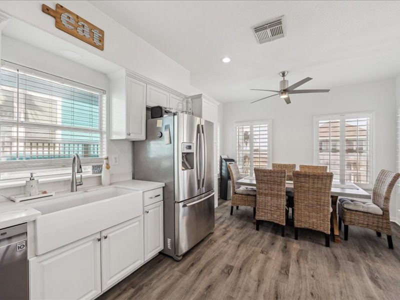 530 Dolphin Street Freeport, TX 77541 - Photo 8 of 29 a kitchen with refrigerator cabinets and wooden floor