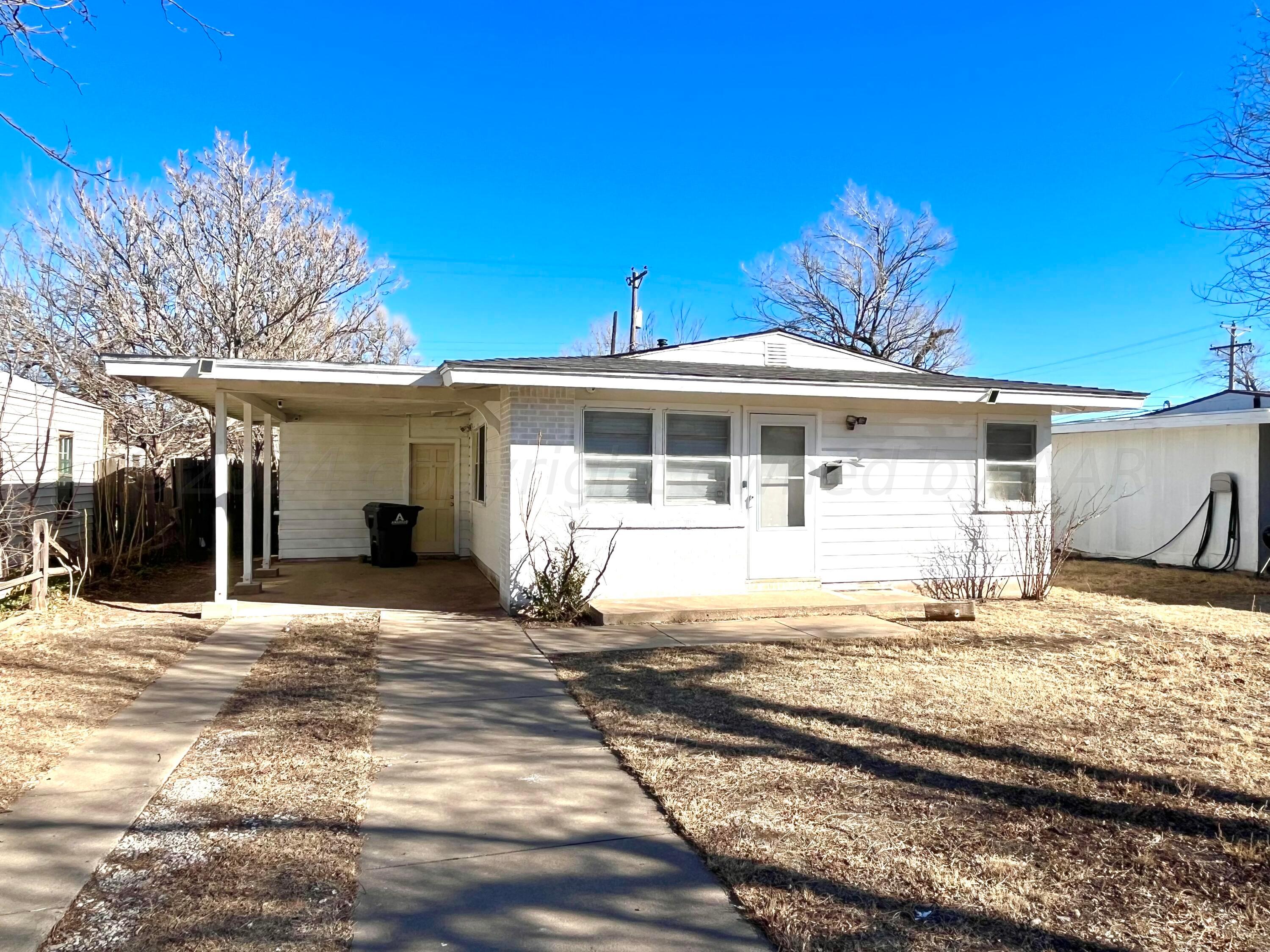4017 Gables Street Amarillo, TX 79110 - Photo 1 of 13 a front view of a house with garden
