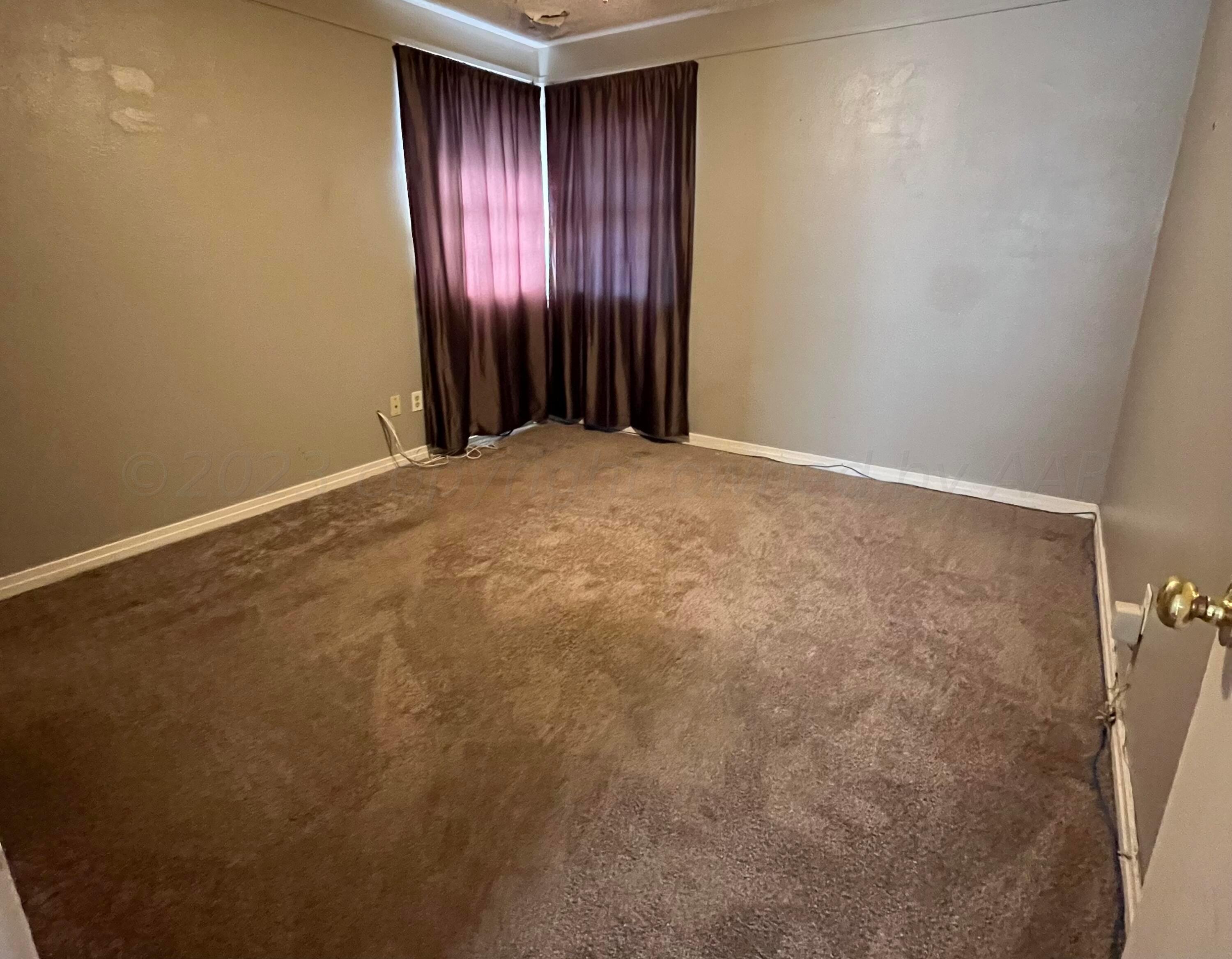 4017 Gables Street Amarillo, TX 79110 - Photo 11 of 13 a view of an empty room with a window