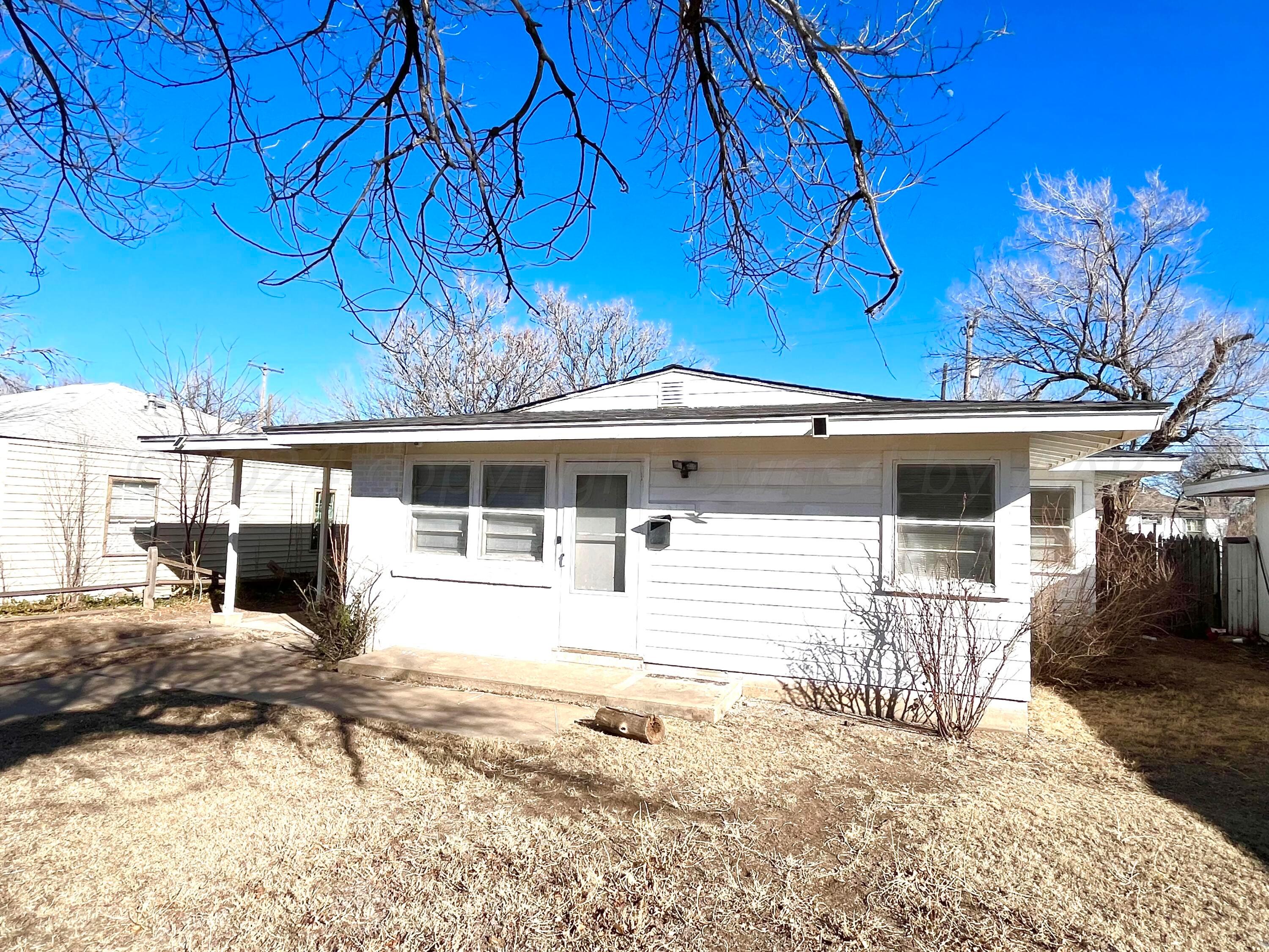 4017 Gables Street Amarillo, TX 79110 - Photo 2 of 13 a front view of a house with a yard and garage
