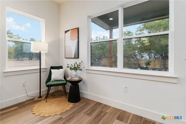 a bedroom with a large bed and a potted plant