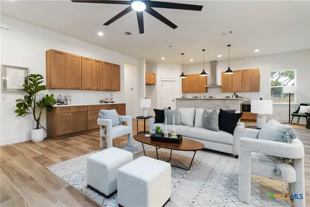 a living room with fireplace furniture and a wooden floor