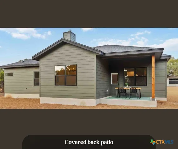 a view of an house with backyard and porch
