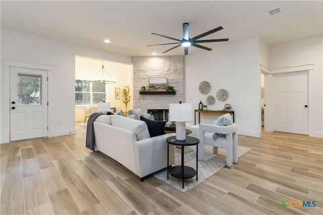 a living room with furniture a table and a potted plant
