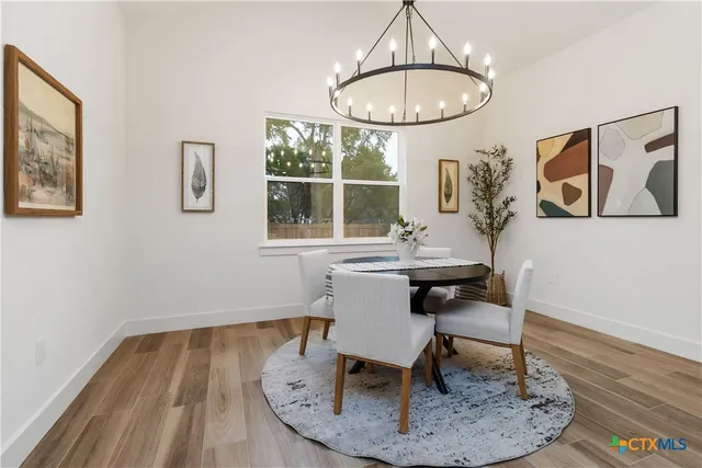 a living room with fireplace furniture and a chandelier