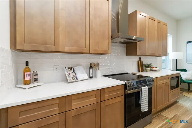 a kitchen with stainless steel appliances white cabinets and a sink