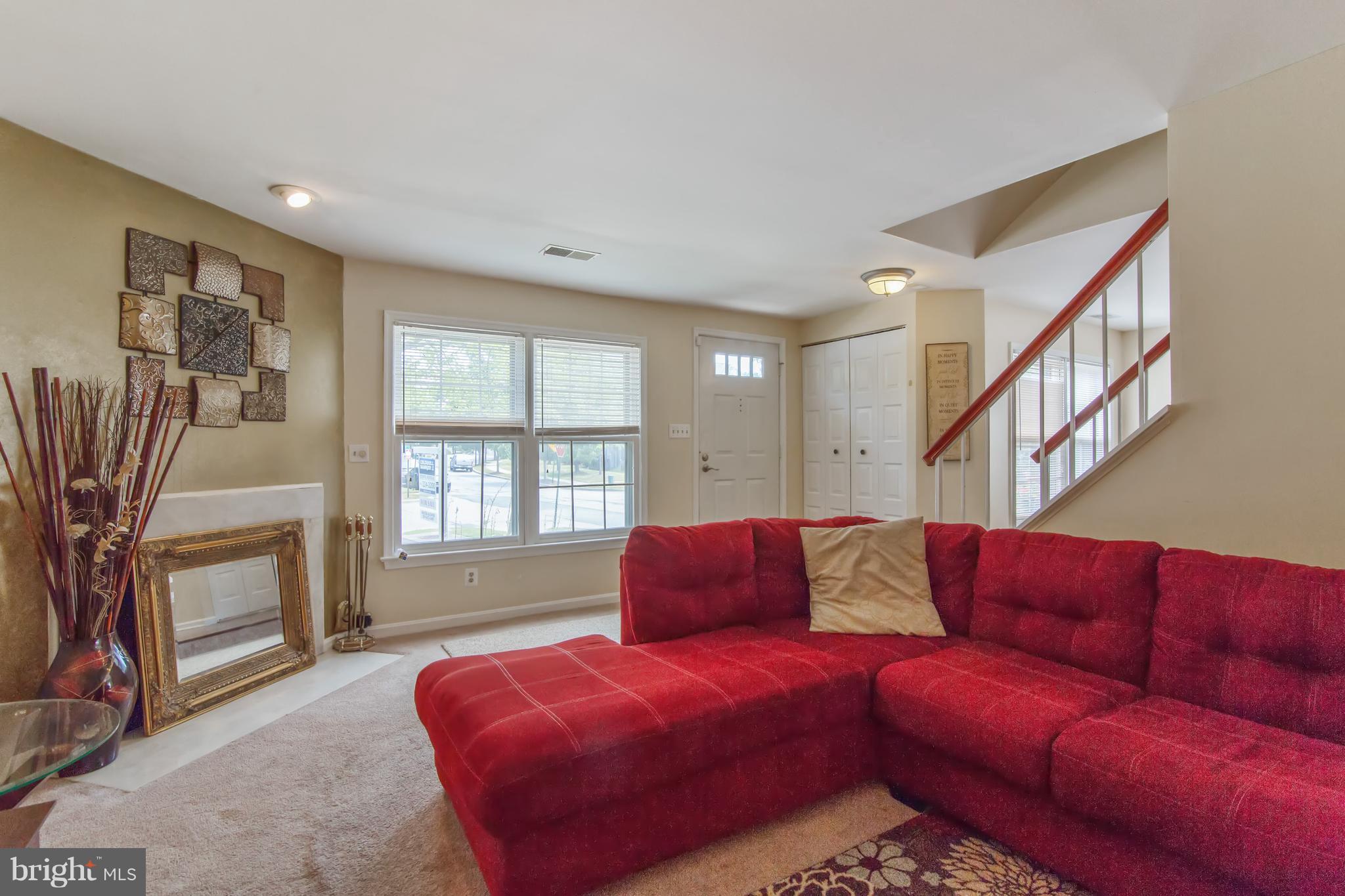 9304 Palmer Place, Unit 5 Laurel, MD 20708 - Photo 6 of 30 a living room with furniture fireplace and a flat screen tv