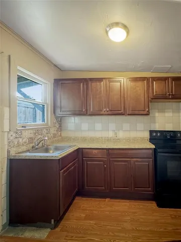 a kitchen with a sink and cabinets