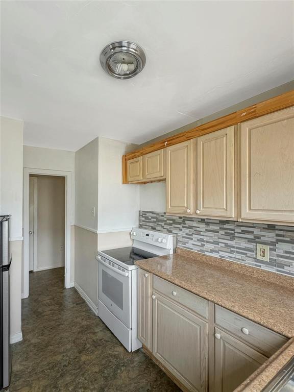 5532 Junius Street Dallas, TX 75214 - Photo 8 of 9 a kitchen with a stove a sink and cabinets