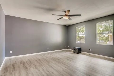 wooden floor in an empty room with a window