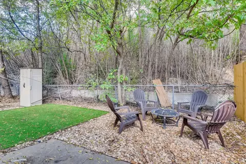 a view of a chairs and table in backyard