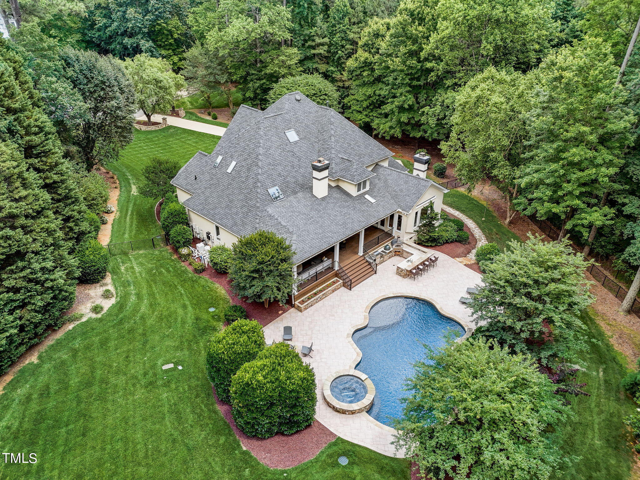 an aerial view of a house with swimming pool and outdoor space