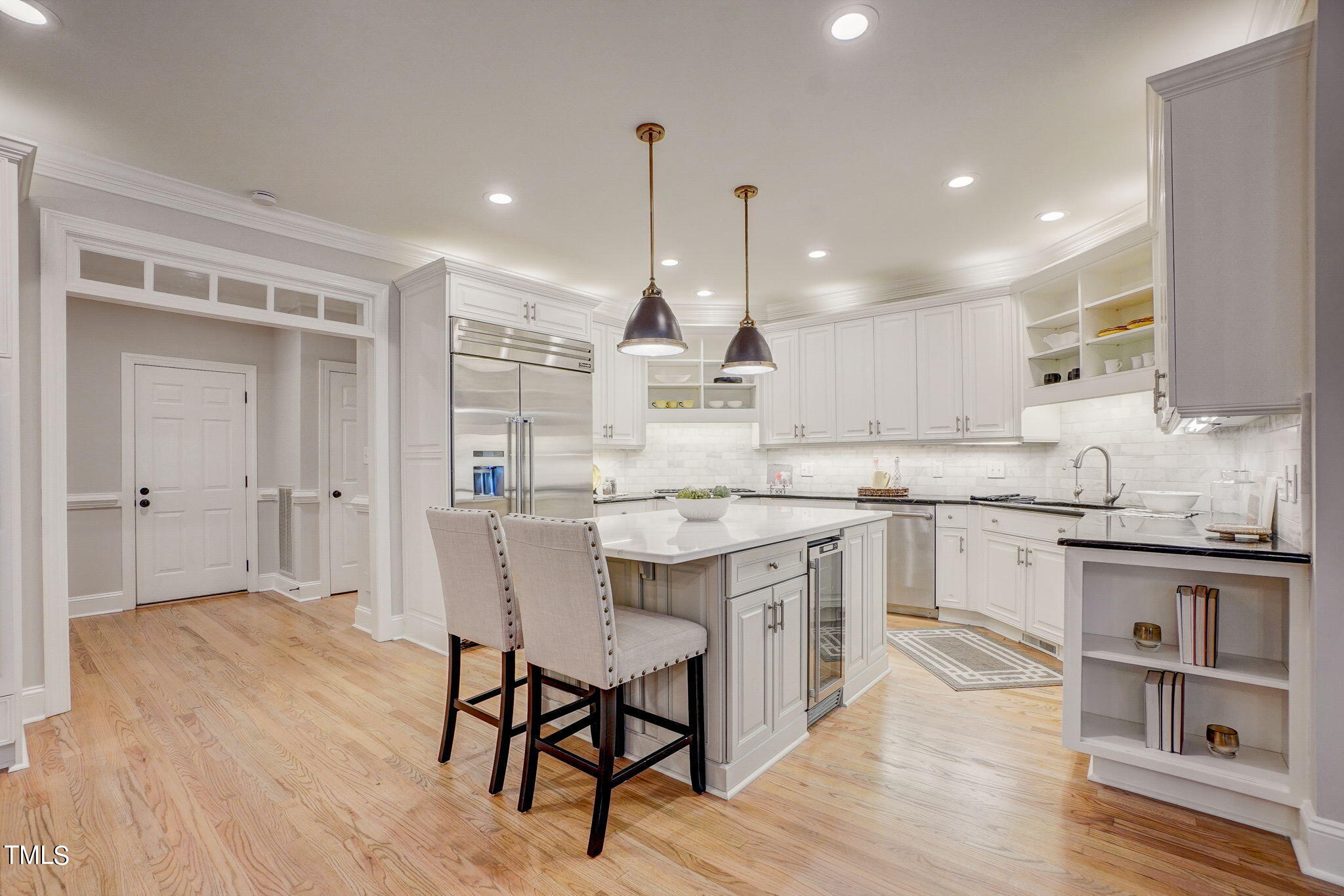 5101 Roseland Court Raleigh, NC 27613 - Photo 11 of 71 a kitchen with stainless steel appliances granite countertop a kitchen island hardwood floor sink and stove