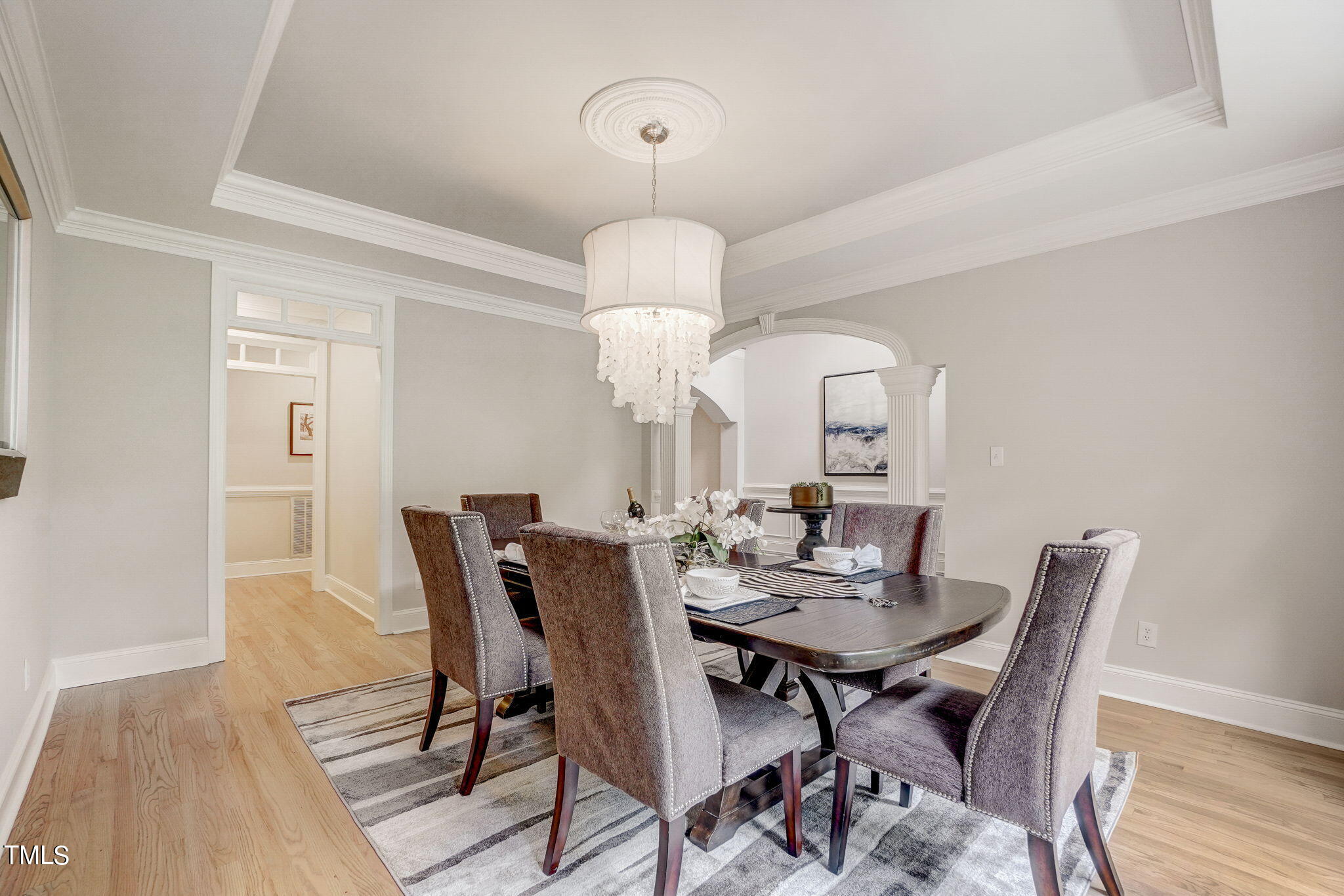 5101 Roseland Court Raleigh, NC 27613 - Photo 20 of 71 a view of a dining room with furniture a chandelier and wooden floor