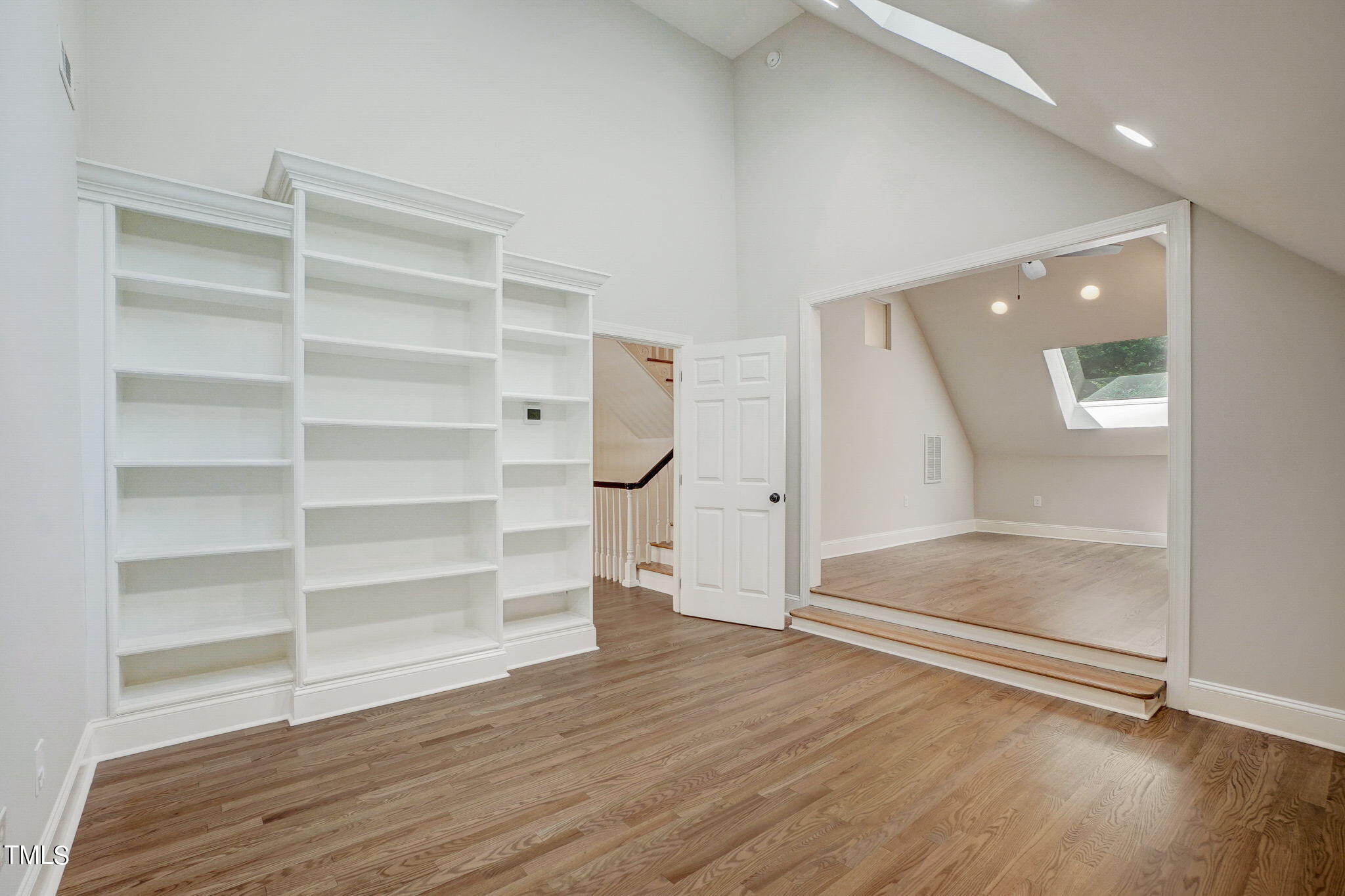 5101 Roseland Court Raleigh, NC 27613 - Photo 50 of 71 a view of an empty room with a window and wooden floor
