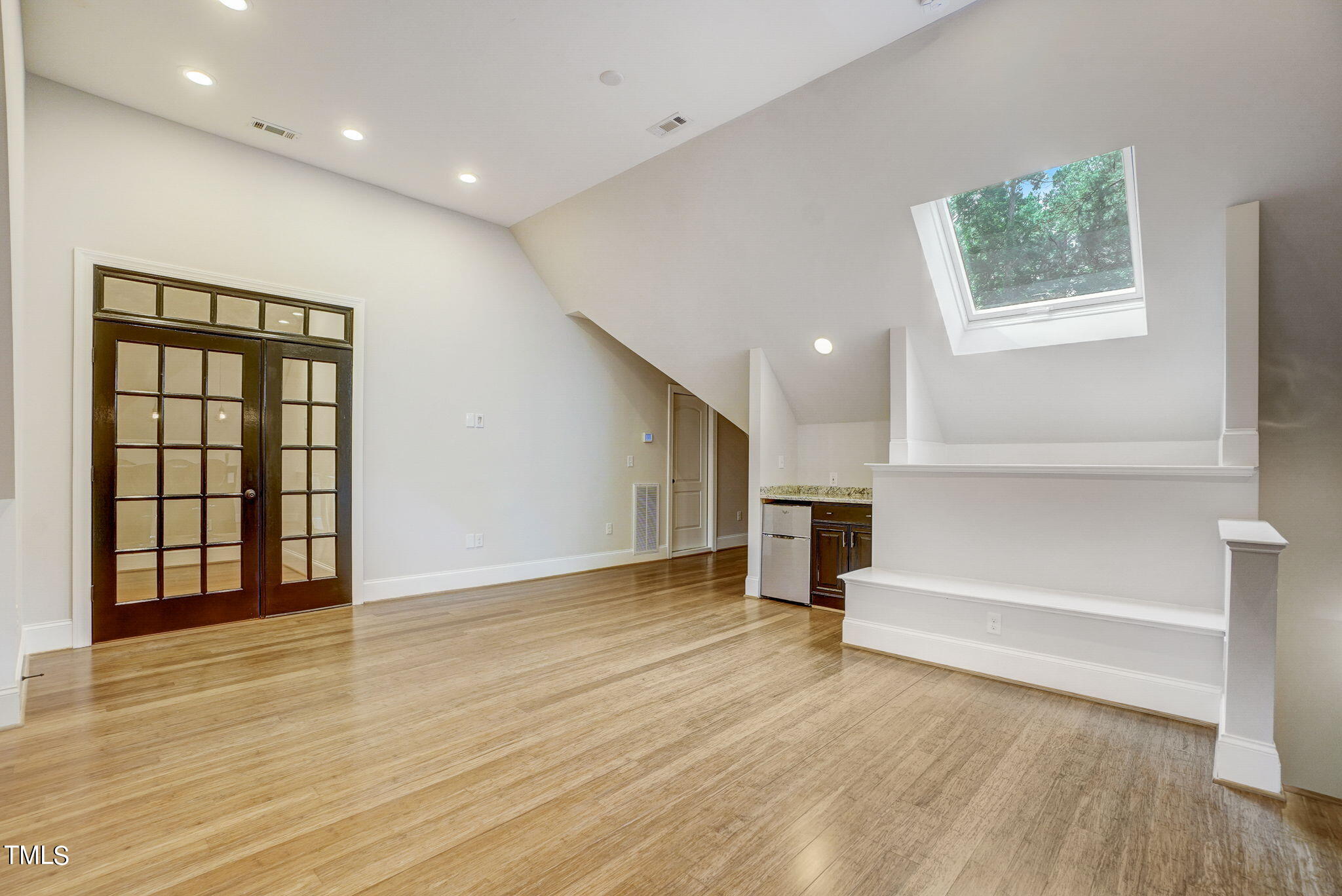 5101 Roseland Court Raleigh, NC 27613 - Photo 54 of 71 an empty room with wooden floor and windows