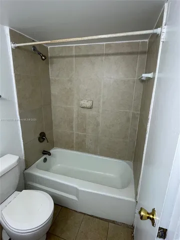 a bathroom with a toilet a sink a mirror and vanity