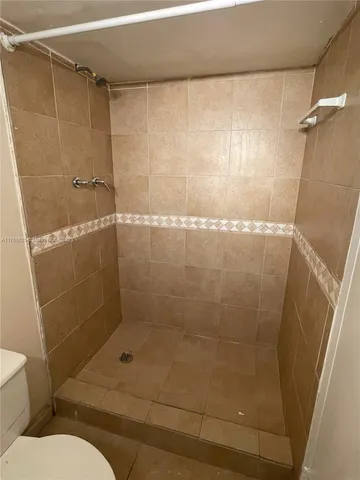 a bathroom with a shower and toilet
