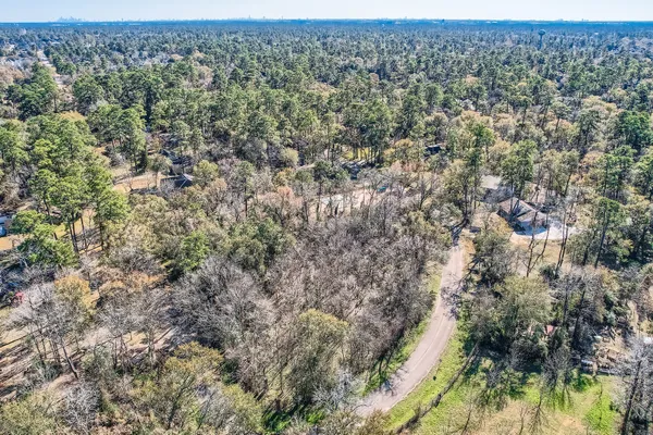 a view of a yard with wooden fence