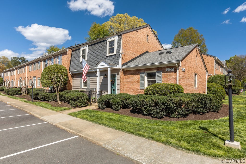 9135 Derbyshire Road, Unit G Henrico, VA 23229 - Photo 3 of 44 a front view of a house with a yard