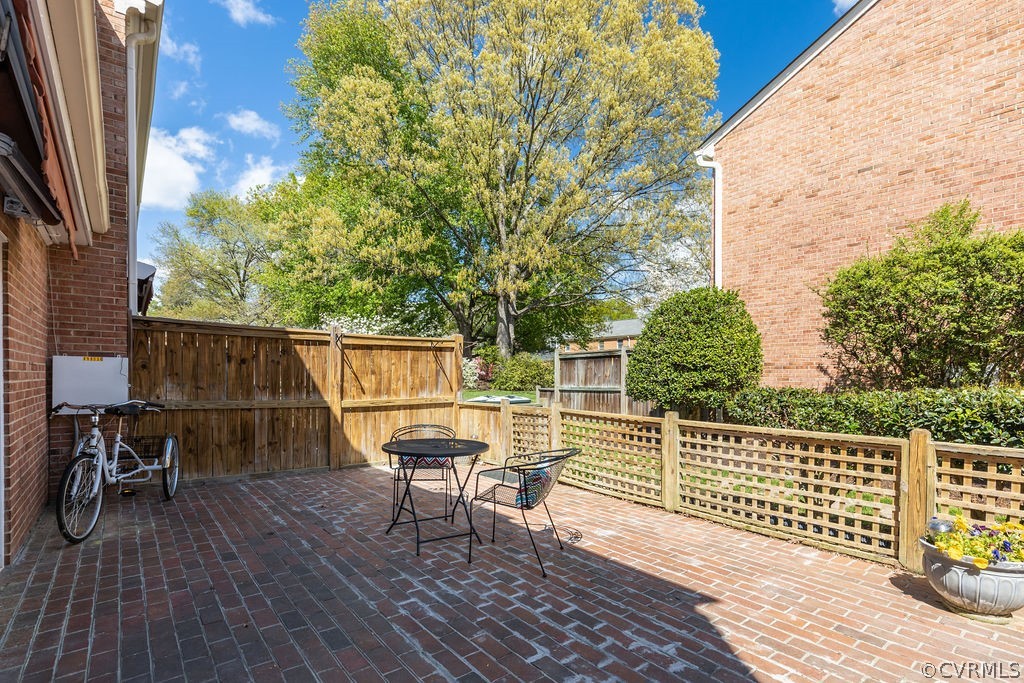 9135 Derbyshire Road, Unit G Henrico, VA 23229 - Photo 35 of 44 a roof deck with table and chairs and wooden floor