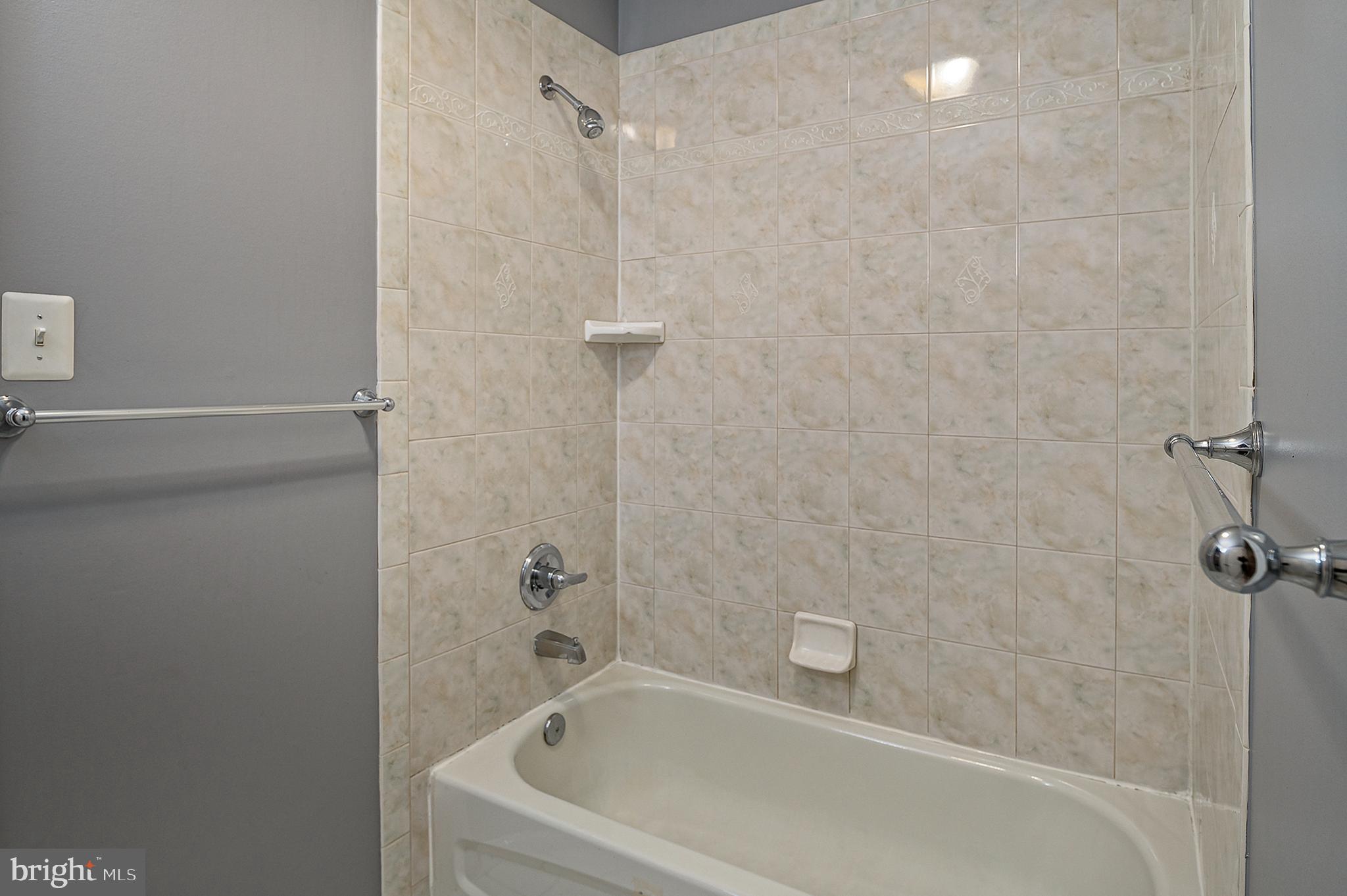 16301 Accolawn Road Accokeek, MD 20607 - Photo 48 of 77 a white bath tub sitting next to a white sink and vanity