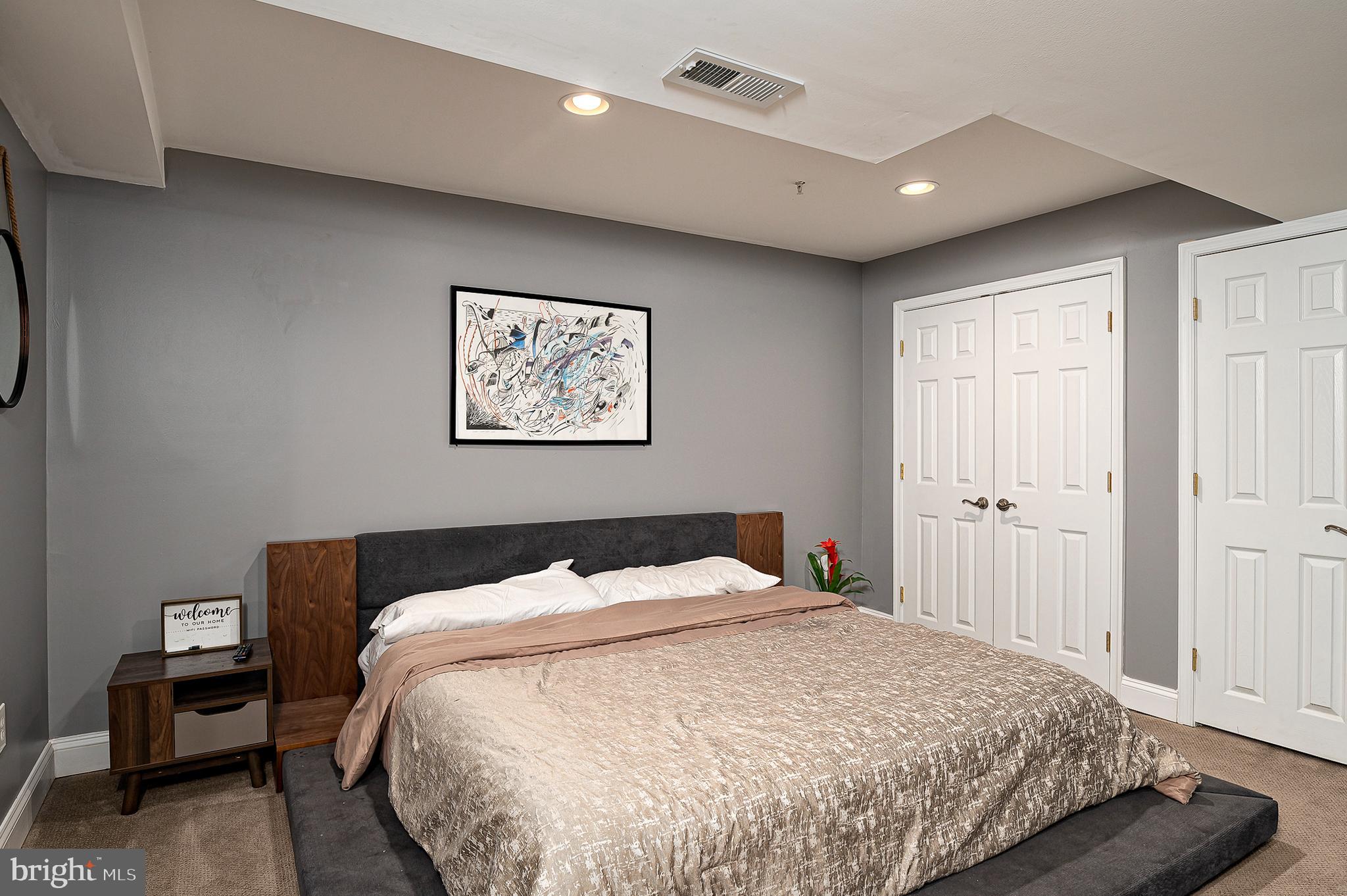 16301 Accolawn Road Accokeek, MD 20607 - Photo 58 of 77 a bedroom with a bed and wooden floor